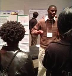 DeAron Washington presenting his winning research poster at the Mid-South Psychology Conference.